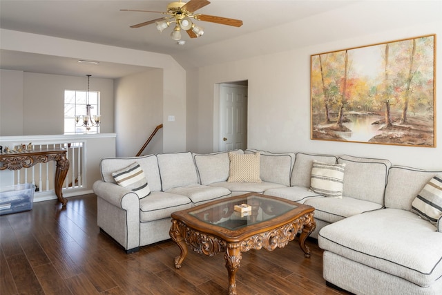 living area featuring ceiling fan with notable chandelier, vaulted ceiling, and wood finished floors