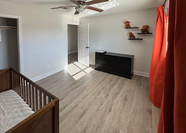 bedroom featuring light wood-type flooring, ceiling fan, and baseboards