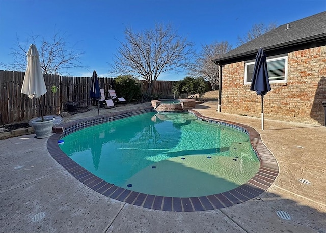 view of pool with a patio area, a fenced backyard, and a pool with connected hot tub