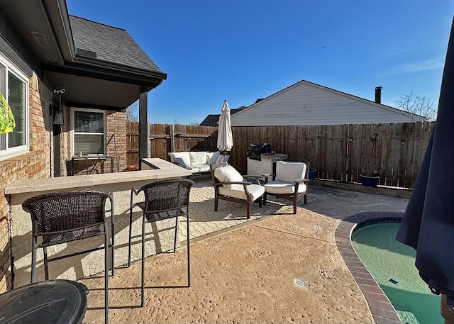 view of patio featuring a fenced backyard, a pool, and an outdoor hangout area