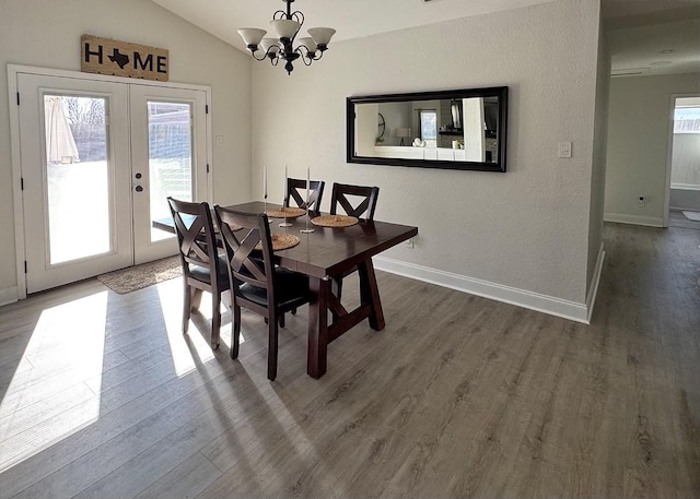 dining space featuring vaulted ceiling, french doors, dark wood-type flooring, and baseboards