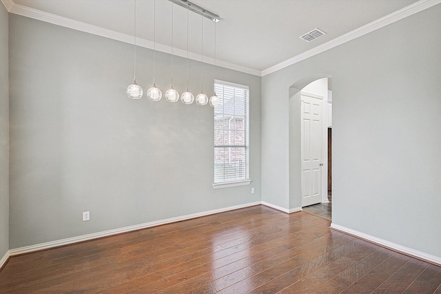 spare room featuring crown molding and dark hardwood / wood-style floors