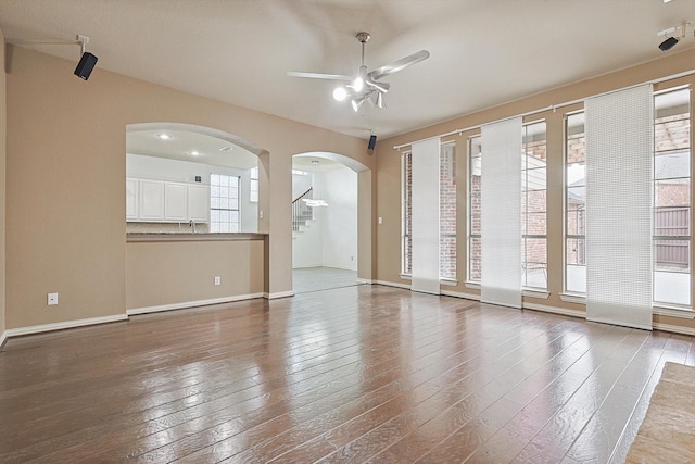 empty room featuring hardwood / wood-style flooring, sink, and ceiling fan