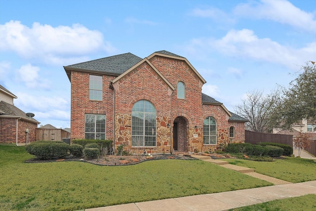 view of property featuring a front lawn