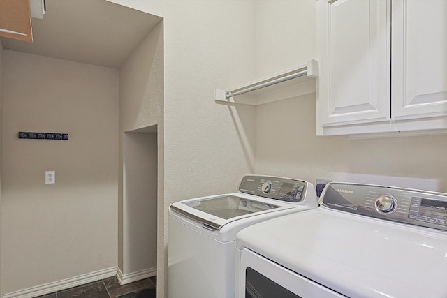 clothes washing area with cabinets and separate washer and dryer