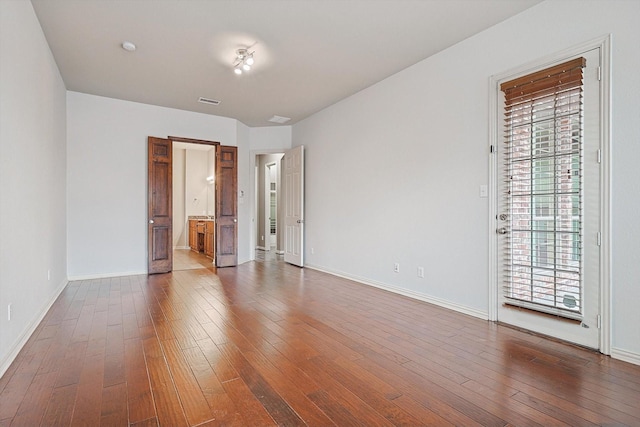 spare room featuring wood-type flooring