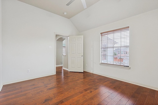 spare room with ceiling fan, lofted ceiling, and dark hardwood / wood-style floors