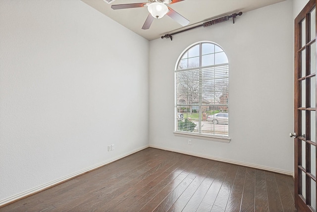 unfurnished room featuring ceiling fan, dark hardwood / wood-style floors, and a healthy amount of sunlight