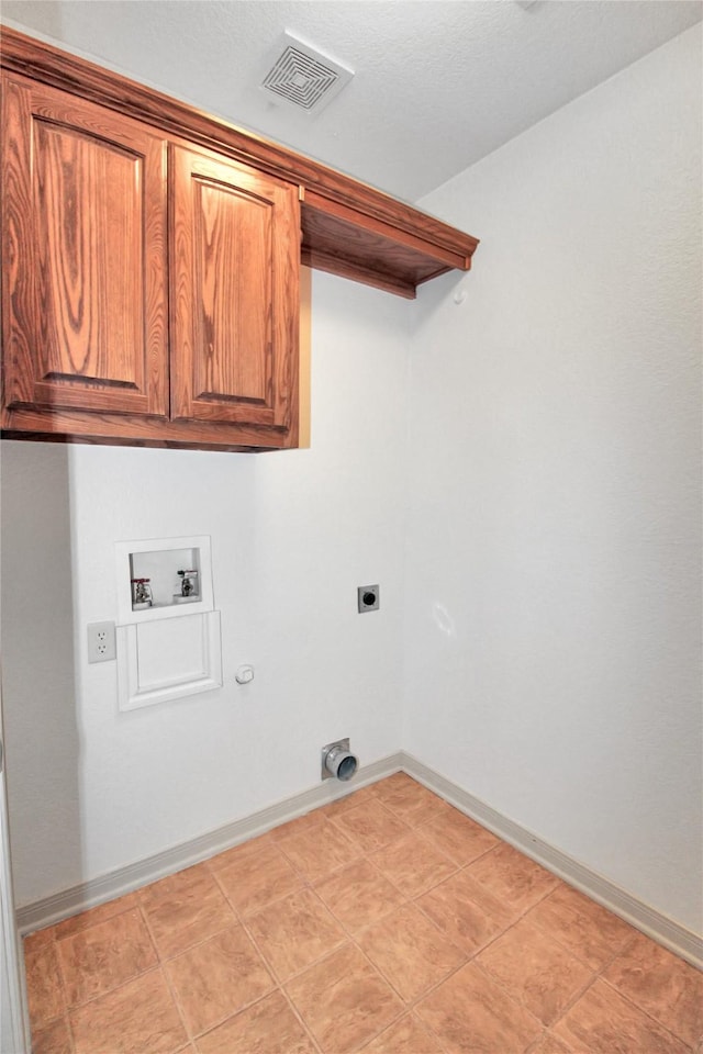 laundry room with cabinets, washer hookup, hookup for an electric dryer, and hookup for a gas dryer