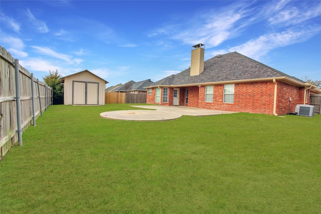 view of yard featuring cooling unit, a storage shed, and a patio area