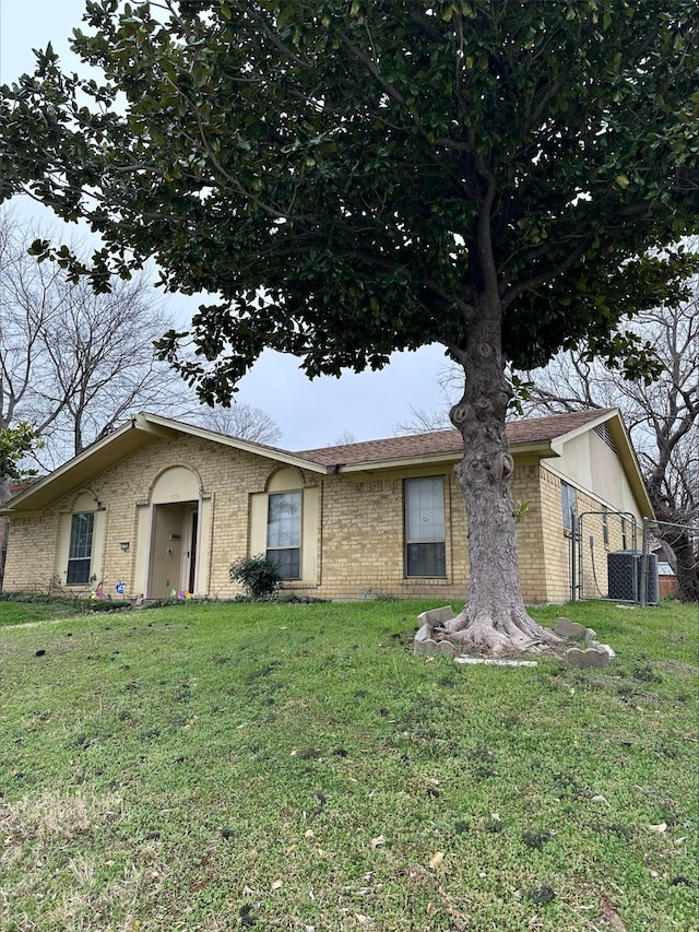 ranch-style home with central AC and a front yard