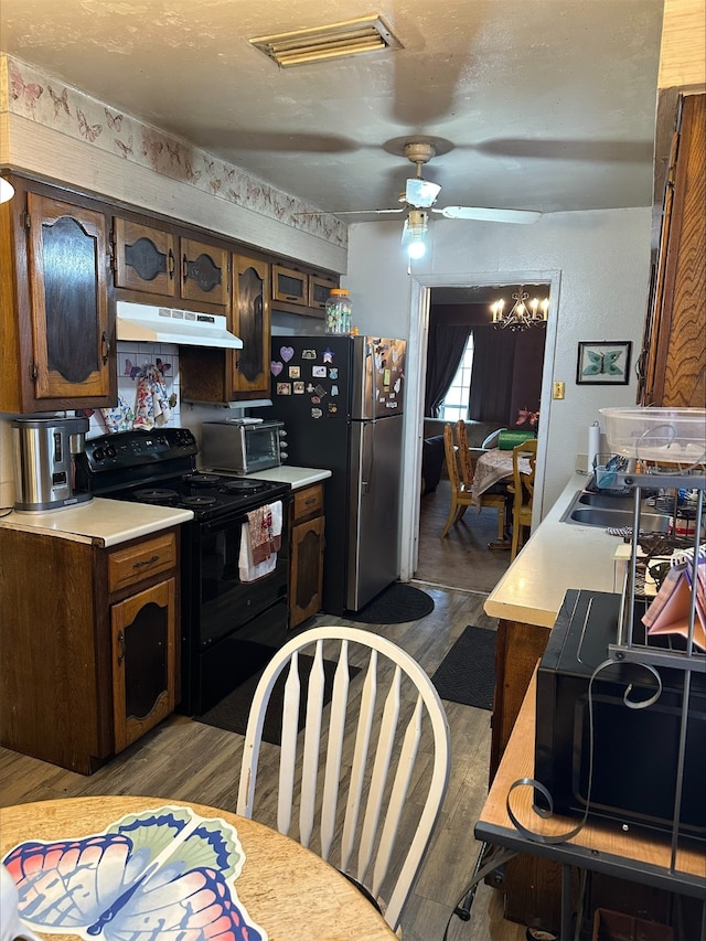 kitchen with stainless steel fridge, dark brown cabinets, black electric range, a textured ceiling, and light wood-type flooring