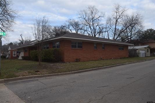 view of property exterior featuring a yard and a storage shed