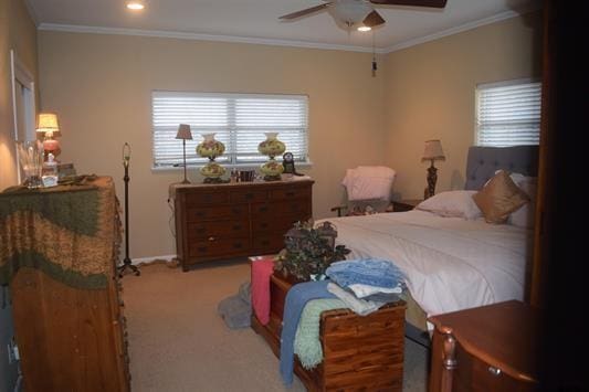 bedroom with crown molding, ceiling fan, and carpet