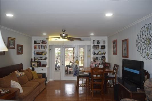 dining room featuring crown molding, wood-type flooring, and ceiling fan