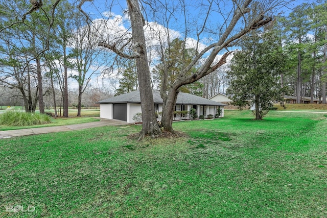 ranch-style house with a garage and a front yard