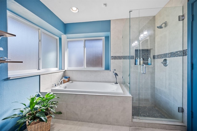 bathroom featuring shower with separate bathtub