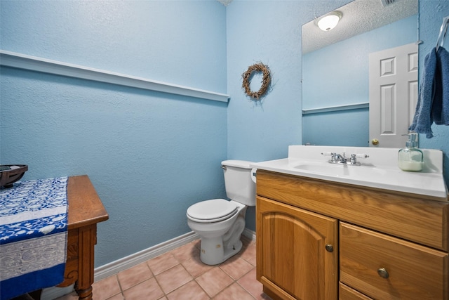 bathroom featuring vanity, tile patterned floors, and toilet