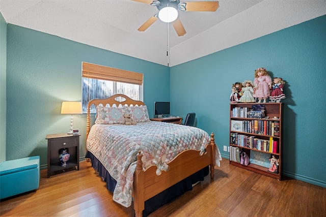 bedroom with vaulted ceiling, hardwood / wood-style floors, and ceiling fan