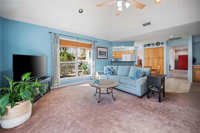 living room with high vaulted ceiling, light colored carpet, and ceiling fan