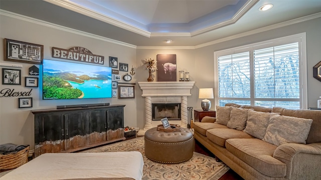 living room with a tray ceiling and ornamental molding