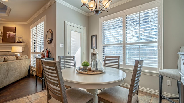 dining area with a notable chandelier, crown molding, and light tile patterned floors