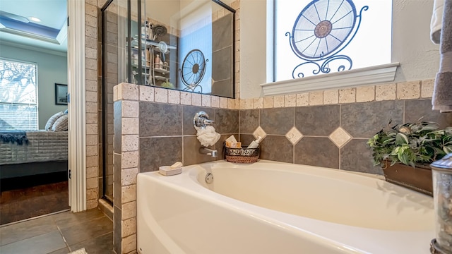 bathroom featuring tile patterned flooring, plus walk in shower, and a healthy amount of sunlight