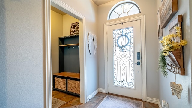 entryway with light tile patterned floors and a wealth of natural light