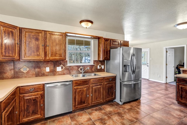 kitchen with stainless steel appliances, tasteful backsplash, sink, and a wealth of natural light