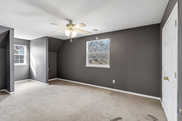 bonus room featuring light carpet, lofted ceiling, and ceiling fan