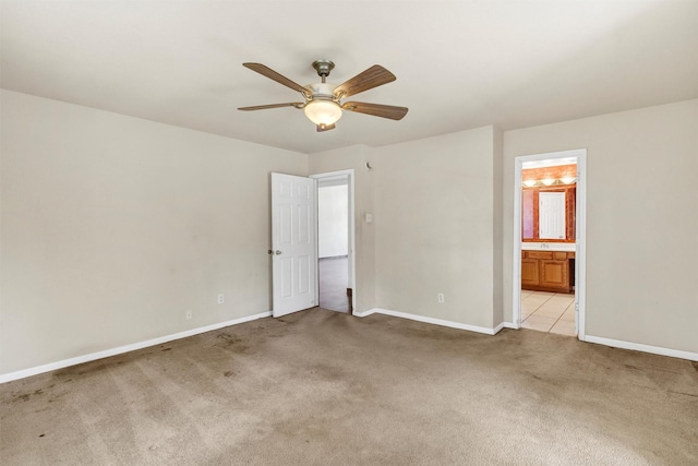 unfurnished bedroom with light carpet, connected bathroom, and ceiling fan