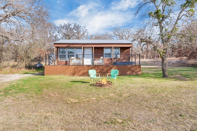 bungalow-style house with a fire pit and a front yard