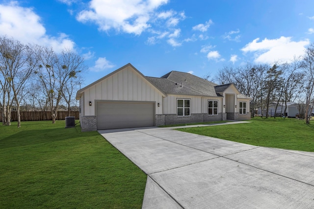 ranch-style home with cooling unit, a garage, and a front yard