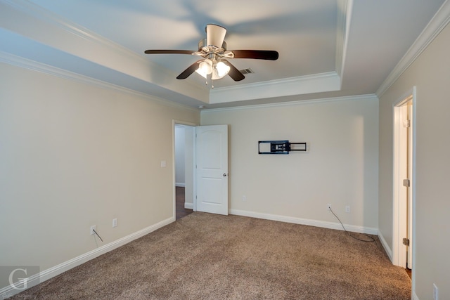 carpeted empty room featuring crown molding, a tray ceiling, and ceiling fan