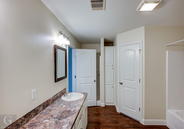 bathroom featuring vanity and hardwood / wood-style floors