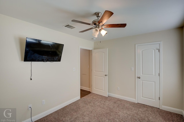 unfurnished bedroom featuring ceiling fan and carpet flooring