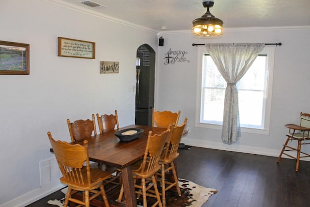 dining area featuring ornamental molding and dark hardwood / wood-style floors