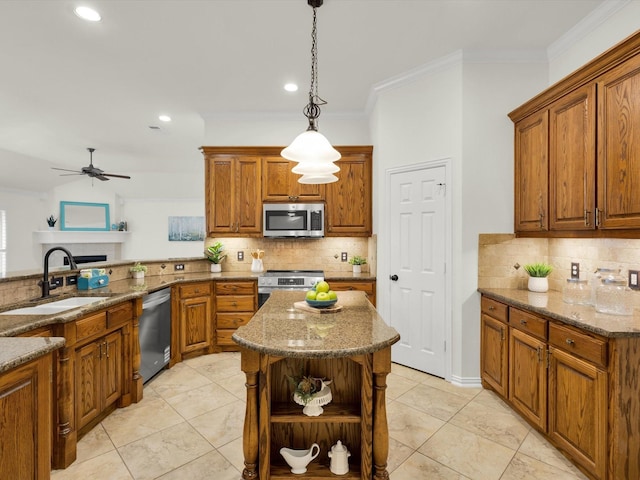 kitchen with sink, decorative light fixtures, ornamental molding, and appliances with stainless steel finishes