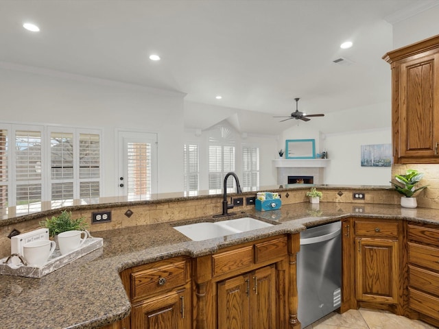 kitchen featuring ornamental molding, dark stone counters, dishwasher, and sink