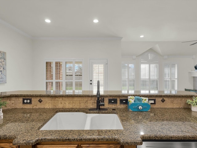 kitchen with sink, crown molding, and dishwasher