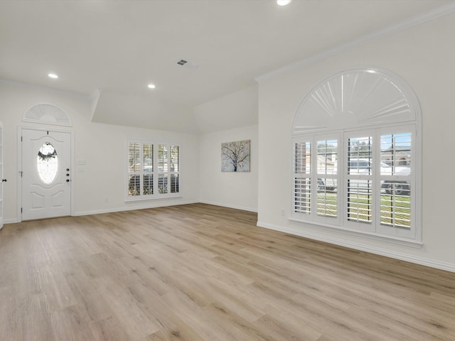 entryway featuring ornamental molding and light hardwood / wood-style flooring