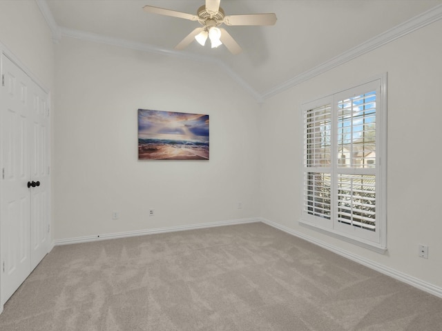 unfurnished bedroom with lofted ceiling, crown molding, light colored carpet, and ceiling fan