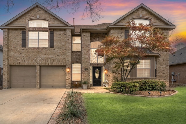 french country home featuring a garage, a front yard, brick siding, and driveway