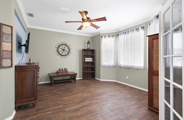 living area featuring dark wood-type flooring, plenty of natural light, visible vents, and crown molding