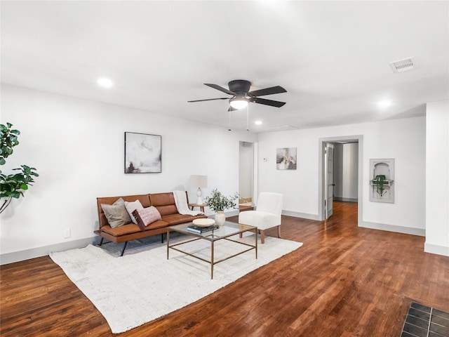 living room featuring dark hardwood / wood-style floors and ceiling fan