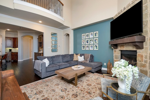 1844 Halifax St, Roanoke, TX 76262 - living area featuring arched walkways, dark wood-type flooring, a fireplace, crown molding, and baseboards