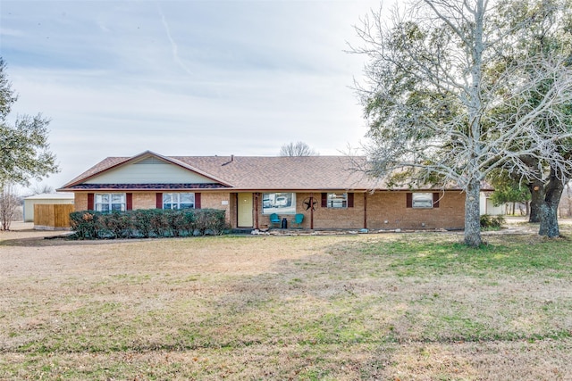 single story home with a front lawn