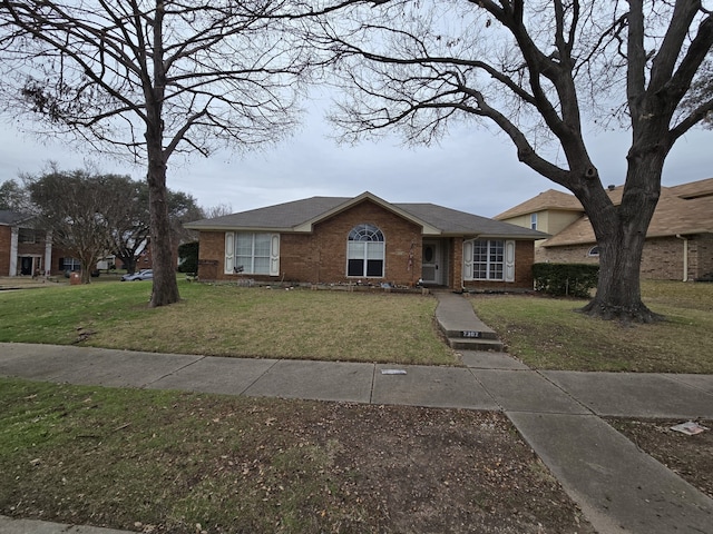 ranch-style home with a front lawn