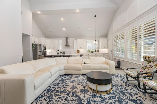 living room with light hardwood / wood-style flooring and high vaulted ceiling