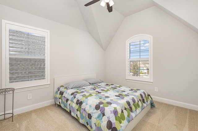 bedroom featuring light carpet, lofted ceiling, and ceiling fan